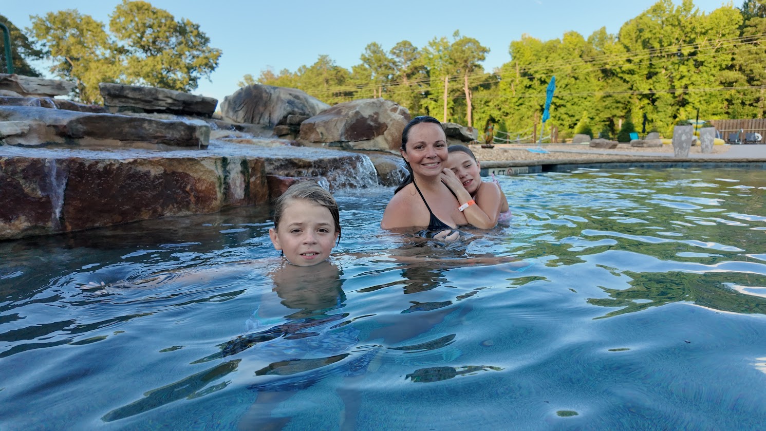 Family enjoying the swimming pool at Sanwar RV Park Resort in Sandersville, Georgia