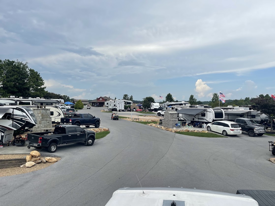 Road winding through RV sites with several parked RVs visible.