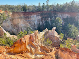Rugged canyon landscape with layered red and white rock formations at Providence Canyon.