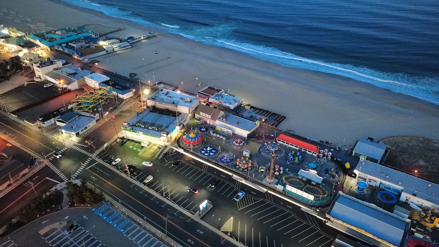 Aerial view of amusement rides and the beach at night in Point Pleasant.