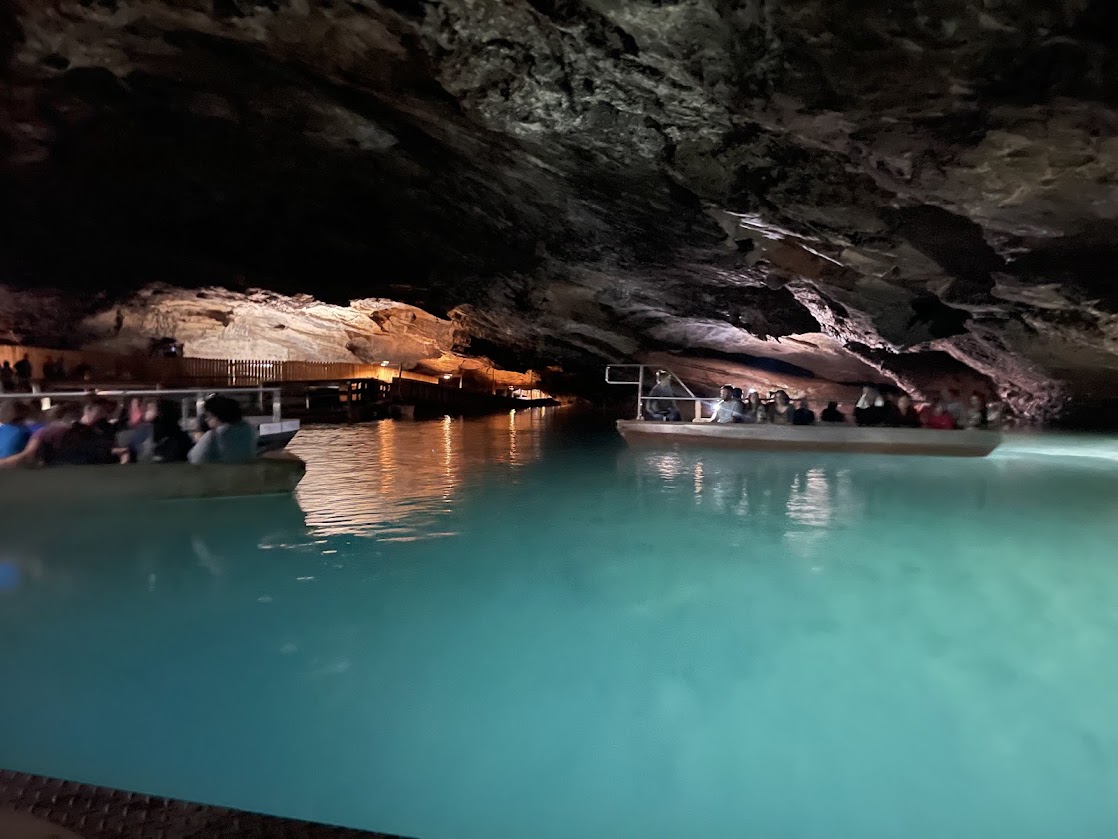 Boats on the turquoise water within The Lost Sea Caverns.