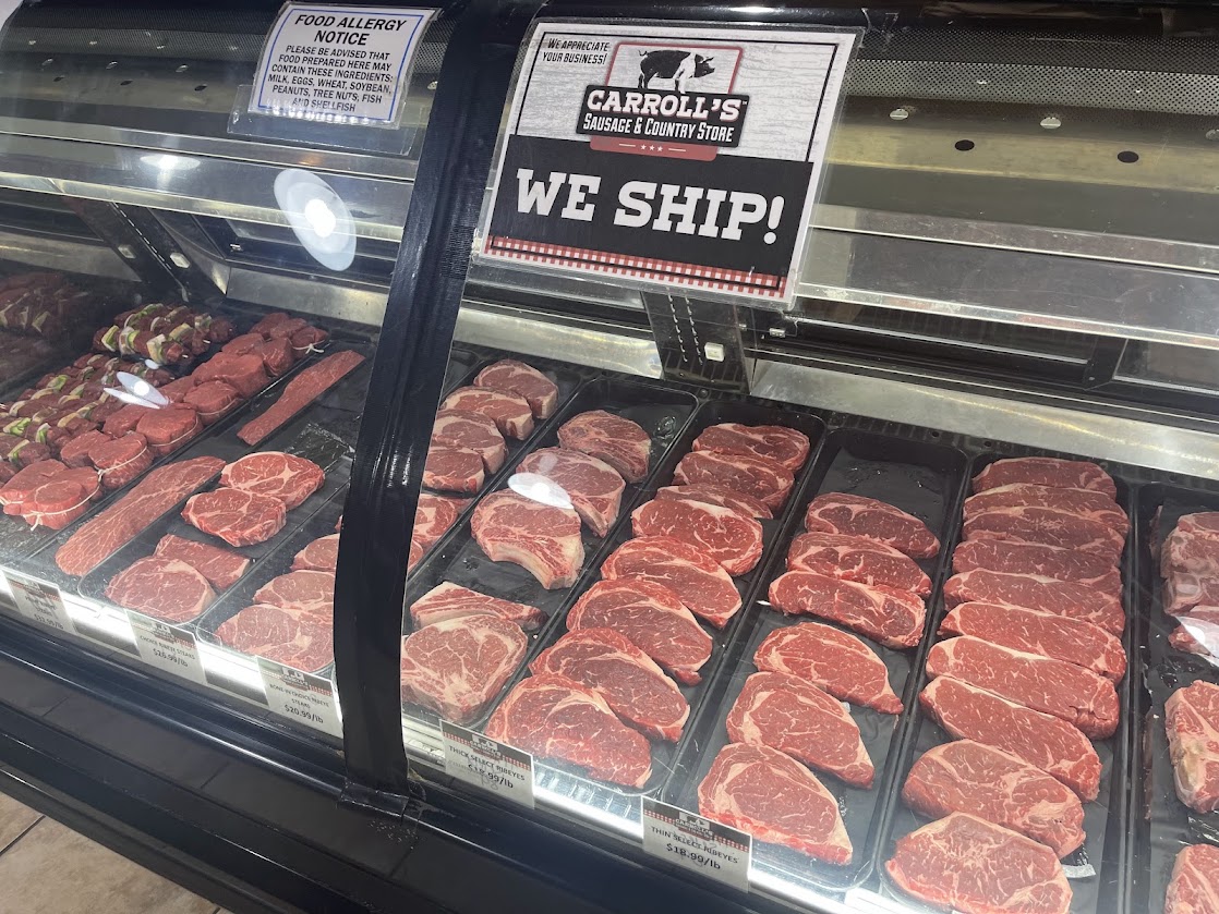 Meat display case featuring various cuts of beef at Carroll's Sausage.